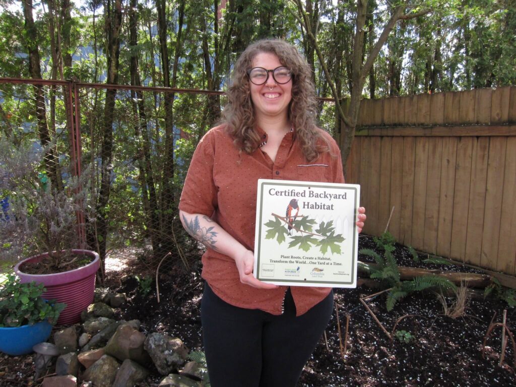 Participants holding Certified Backyard Habitat sign.